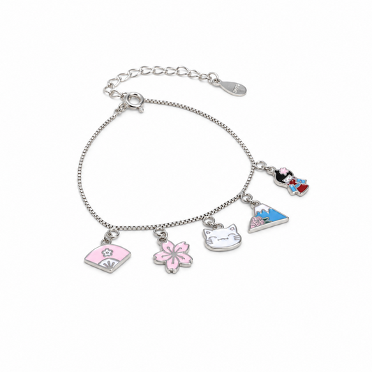 A silver-tone charm bracelet featuring five distinct enamel charms: a pink handbag, a pink cherry blossom, a white cat head, a blue mountain, and a Mickey Mouse and Minnie Mouse design, displayed on a clean white background.