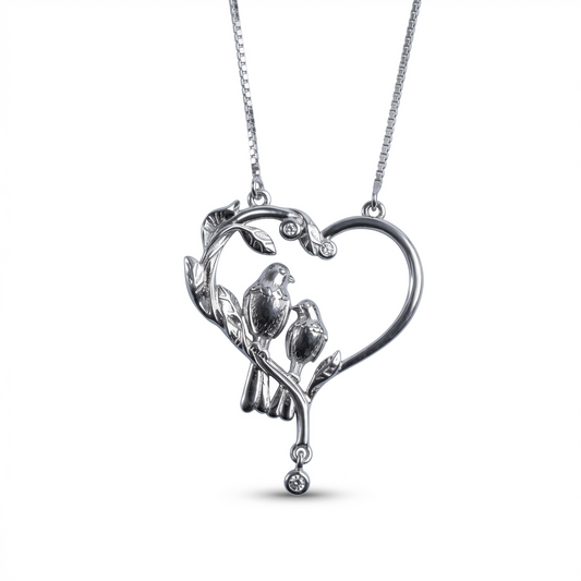 Heart-shaped pendant with birds on a branch on a white background