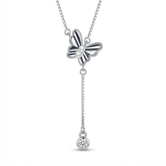 Butterfly-shaped pendant necklace with a pearl and gemstone on a white background